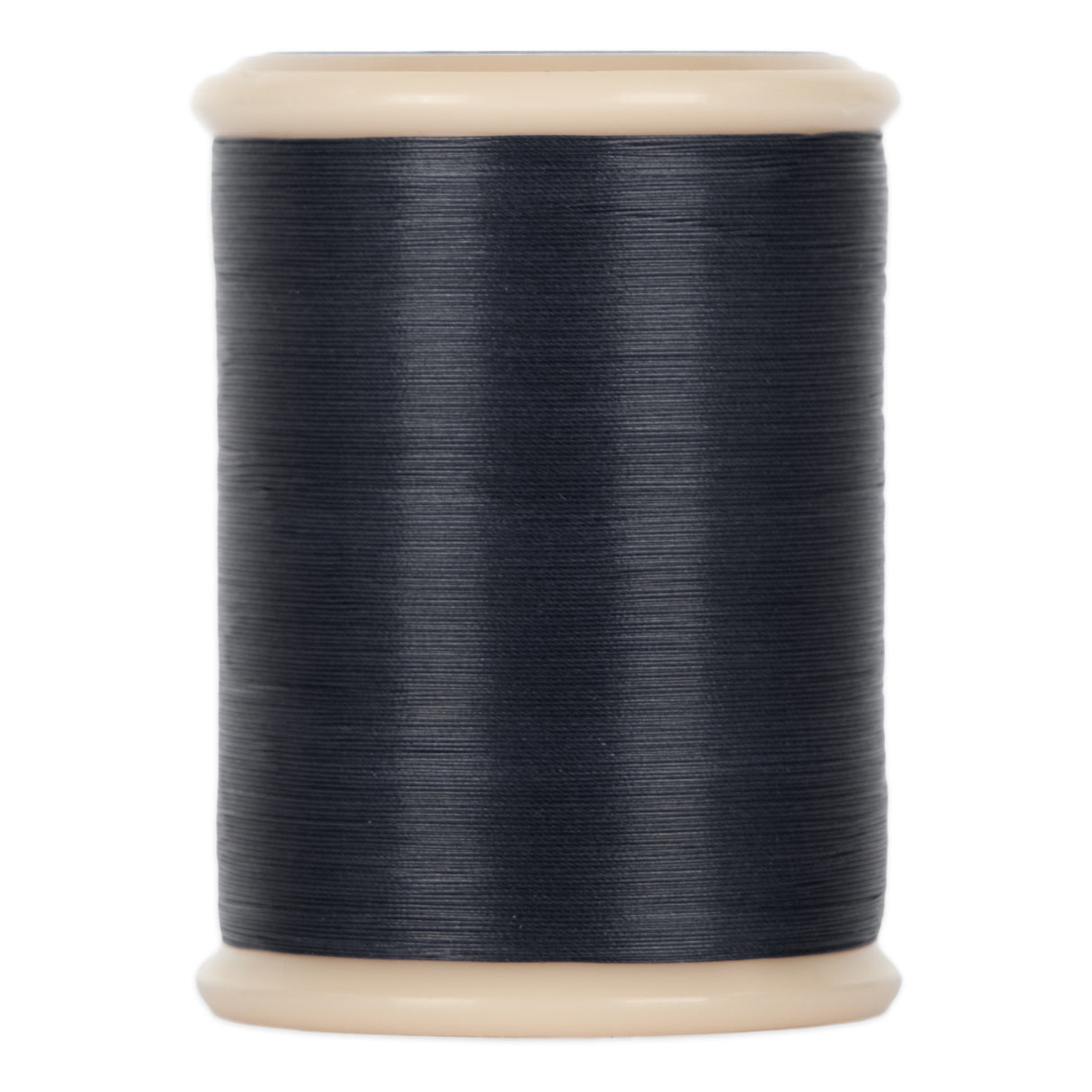 A spool of dark blue yli threads hand quilting thread on a 500 yd spool
