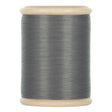 A spool of dark gray cotton hand quilting thread from YLI threads