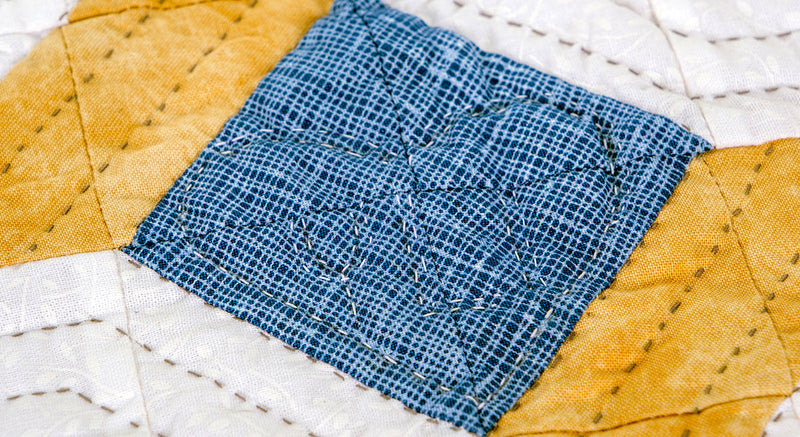 hand quilted block showing decorative stitching with cotton hand quilting thread