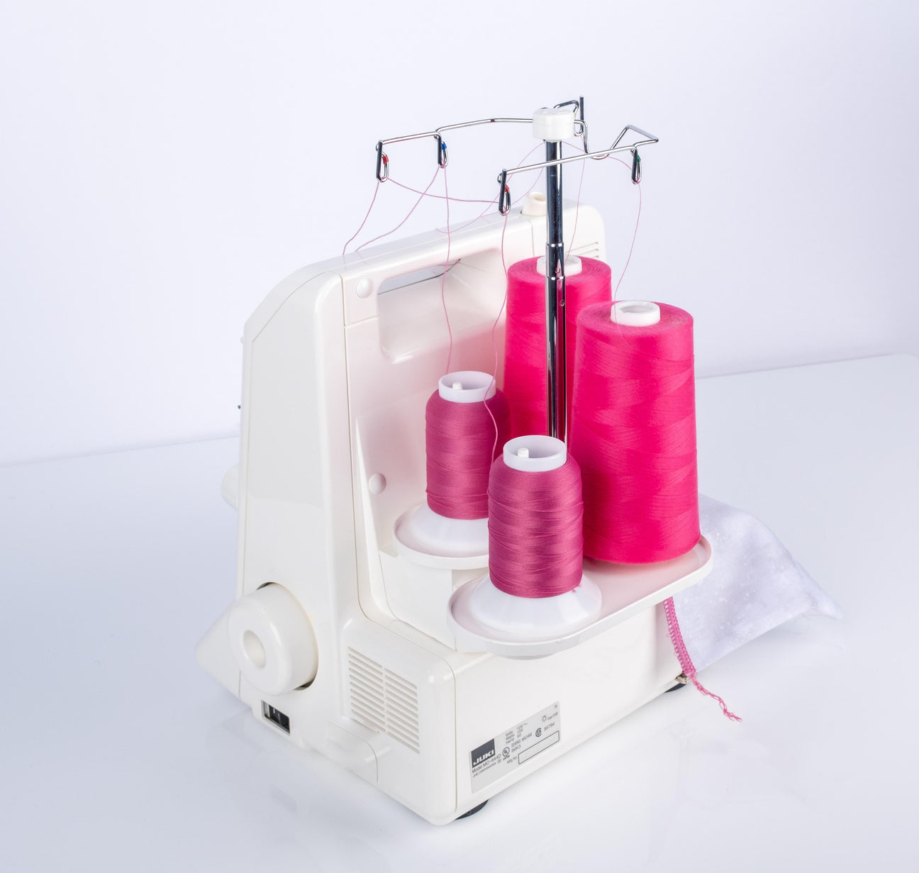 a serger machine with pink woolly nylon thread in the loopers