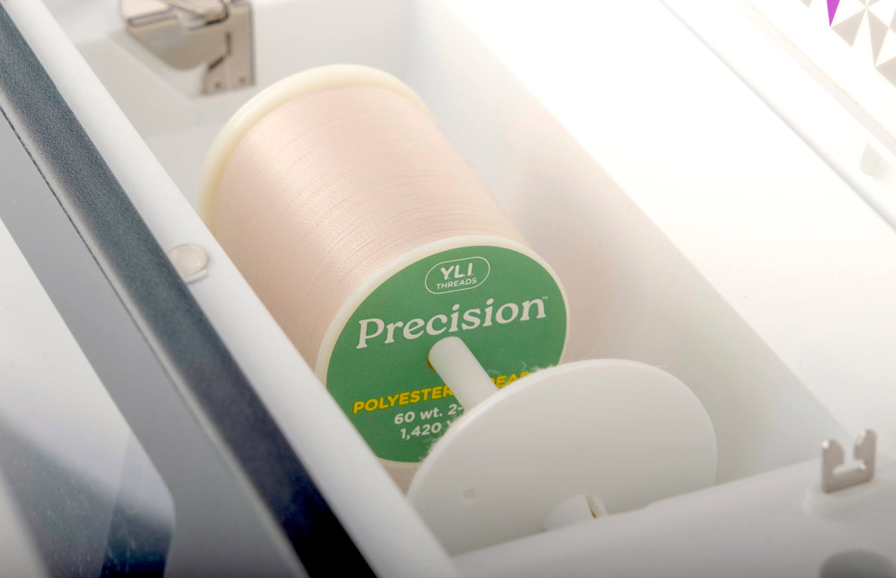 a spool of precision thread on a sewing machine