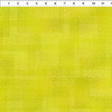 Yellow green textured tonal fabric.