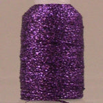 Purple sparkly thread on white spool with metallic finish and visible thread end