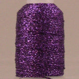 Purple sparkly thread on white spool with metallic finish and visible thread end