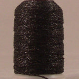 Black metallic thread wound on white plastic spool with visible sparkly texture and loose thread end