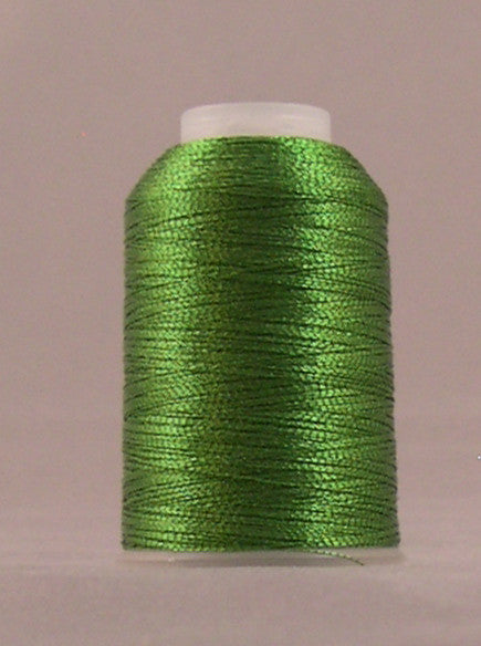 Spring green metallic thread wound on white plastic spool against neutral background