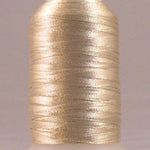 Champagne metallic thread on white plastic spool with lustrous gold finish