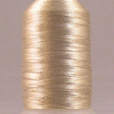 Champagne metallic thread on white plastic spool with lustrous gold finish