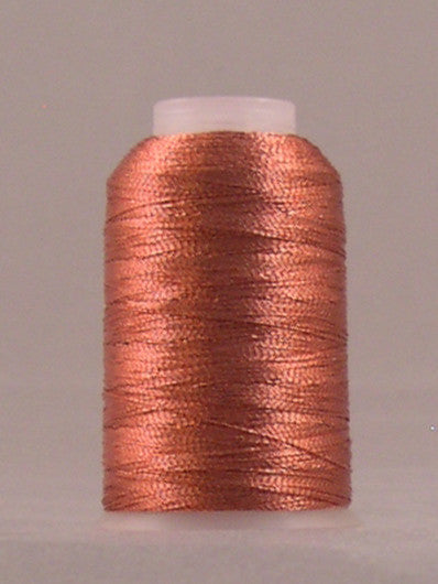 Terra cotta metallic thread wound on white plastic spool with shimmery copper-orange finish