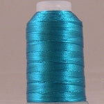 Sapphire blue metallic thread wound on white plastic spool with shiny finish
