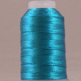 Sapphire blue metallic thread wound on white plastic spool with shiny finish