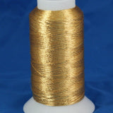 Gold metallic thread on white plastic cone with blue background