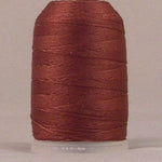 Brown jeans stitch thread on white plastic spool with neatly wound layers