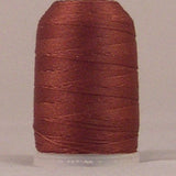 Brown jeans stitch thread on white plastic spool with neatly wound layers
