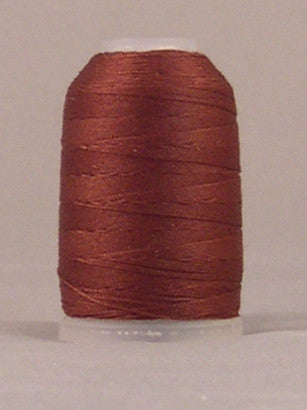 Brown jeans stitch thread on white plastic spool with neatly wound layers