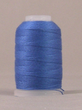 Royal blue 12 weight thread wound on white plastic spool with visible thread end