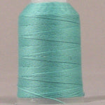 Sea foam green thread wound on white plastic spool with visible thread layers and loose end