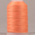 Peach colored thread wound on white plastic spool with pink cap