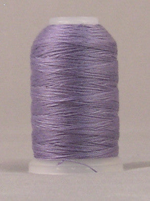 Orchid purple thread wound on white plastic spool with clean, even wrapping