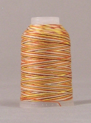 Earthtone variegated 12 wt thread on white plastic spool with orange, yellow, and brown striped pattern
