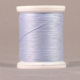 Light blue thread wound on white plastic spool against neutral background