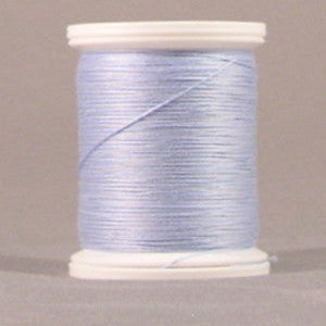 Light blue thread wound on white plastic spool against neutral background