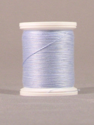 Light blue thread wound on white plastic spool against neutral background