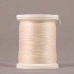 Pale cream colored thread wound on white plastic spool with clear protective caps on both ends