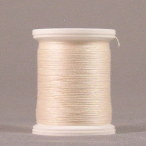 Pale cream colored thread wound on white plastic spool with clear protective caps on both ends