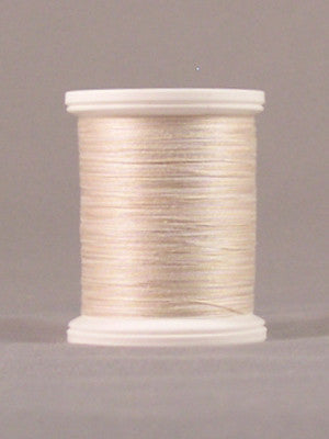 Cream-colored thread on white plastic spool with visible thread windings