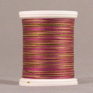 Burgundy and gold variegated thread on white plastic spool with visible thread wrapping