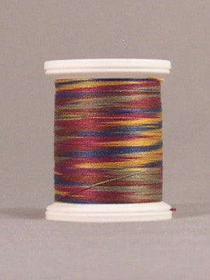 Multicolored variegated thread in burgundy, gold, and green tones wound on white plastic spool