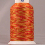 Gerbera variegated thread in orange and yellow tones wound on white plastic cone with YLI brand label