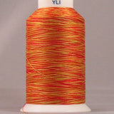 Gerbera variegated thread in orange and yellow tones wound on white plastic cone with YLI brand label