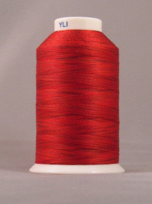 Red embroidery thread on white cone spool with YLI label, showing smooth wound thread in bright red Indian Paintbrush color