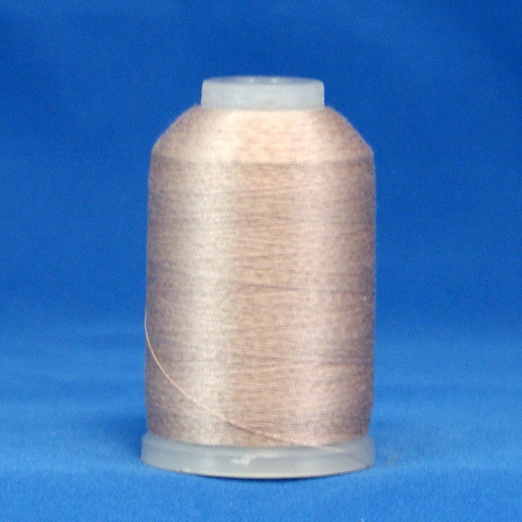 Light taupe thread wound on white plastic cone against blue background