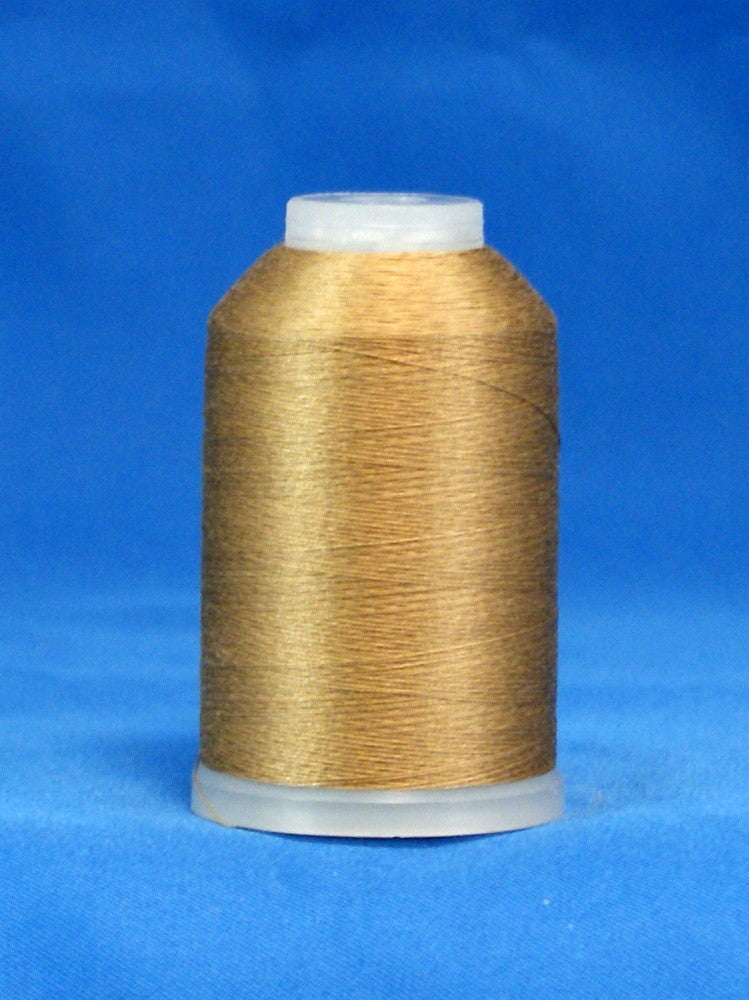 Light brown 60 weight thread on white plastic cone against blue background