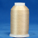 Natural colored thread wound on white plastic cone against blue background