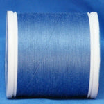 Medium blue 60 weight thread on white plastic spool against blue background