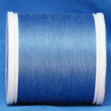 Medium blue 60 weight thread on white plastic spool against blue background