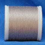 Light taupe thread wound on white plastic spool against blue background