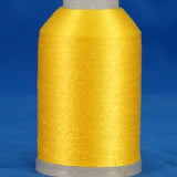 Bright yellow thread wound on white plastic cone against blue background