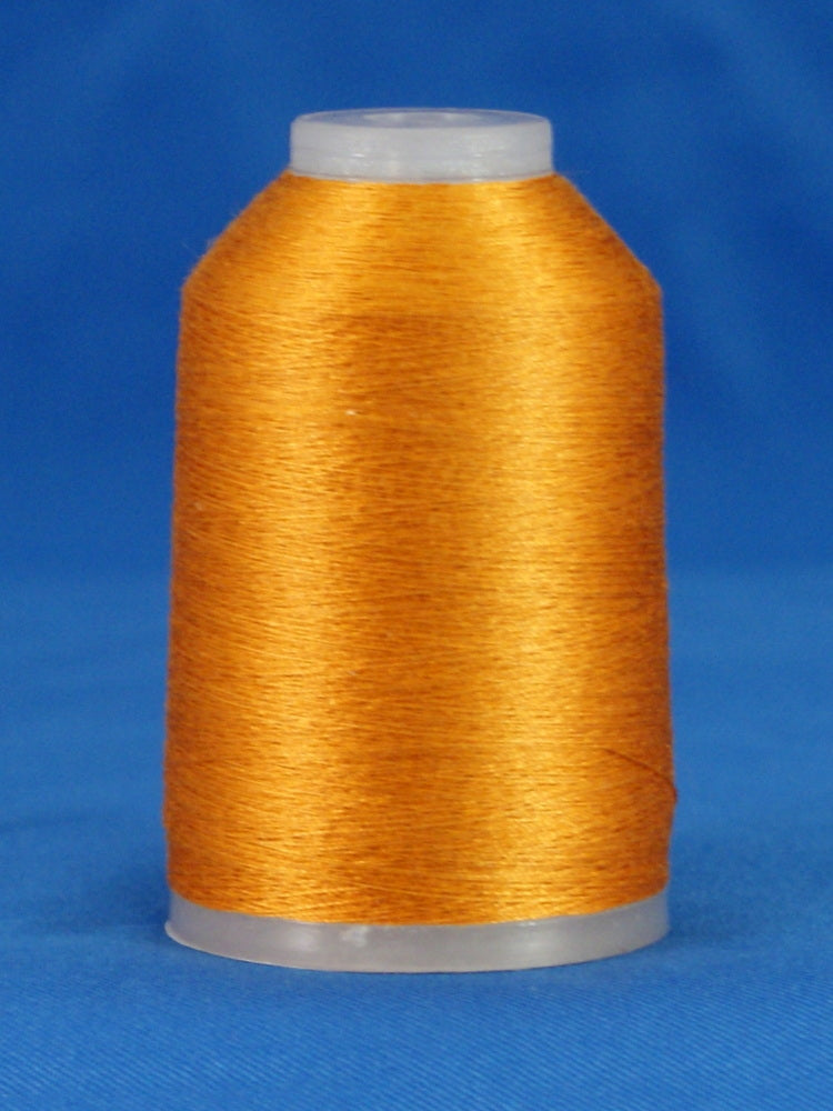 Golden orange embroidery thread wound on white plastic cone against blue background