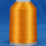Golden orange embroidery thread wound on white plastic cone against blue background