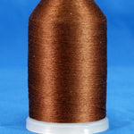 Brown thread wound on white plastic cone with tapered shape against blue background