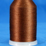 Brown thread wound on white plastic cone with tapered shape against blue background
