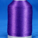 Purple embroidery thread wound on white plastic cone with tapered shape against blue background