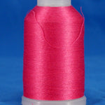 Pink fuschia thread wound on white plastic cone against blue background