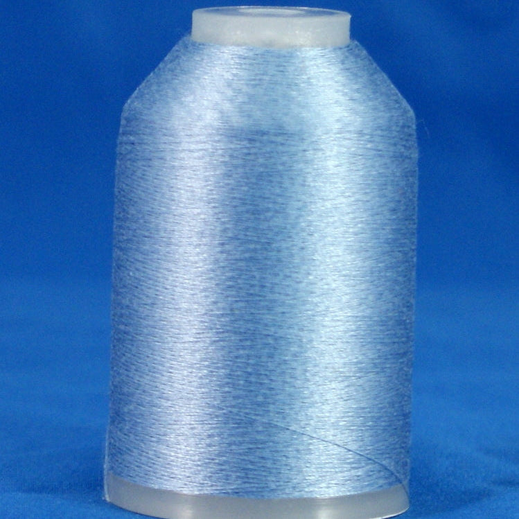 Light blue thread wound on white plastic cone against blue background
