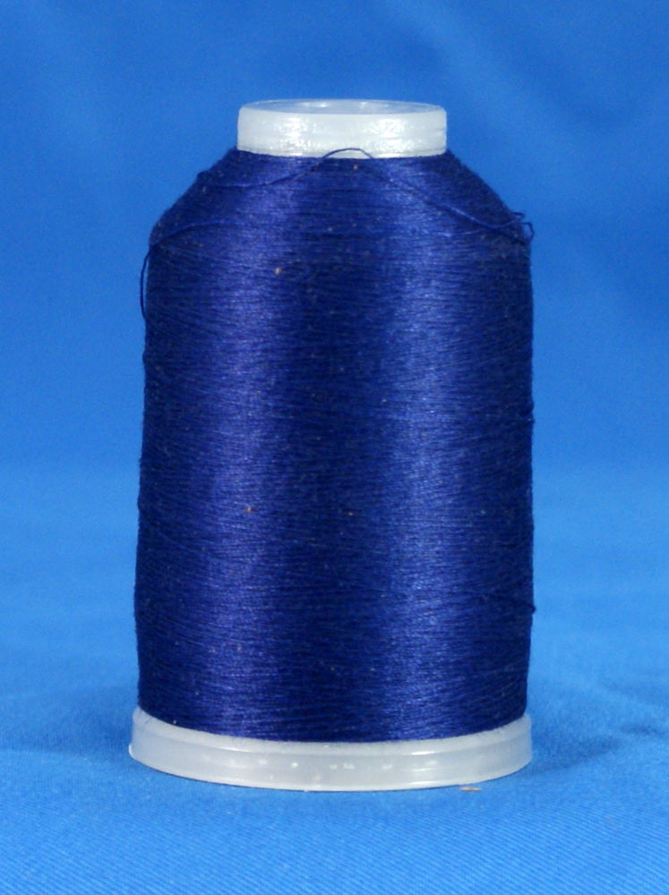 Navy blue thread wound on white plastic cone against blue background